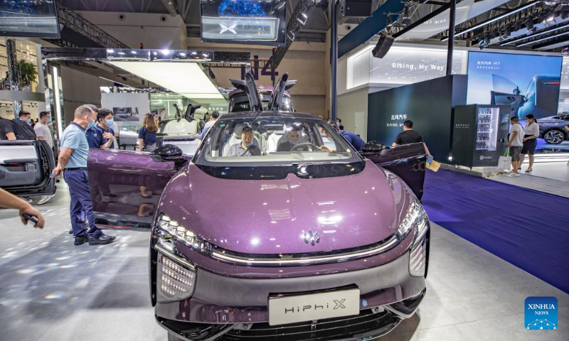 Visitors view a new energy vehicle during the 2022 Chongqing International Auto Exhibition in southwest China's Chongqing Municipality, June 25, 2022.