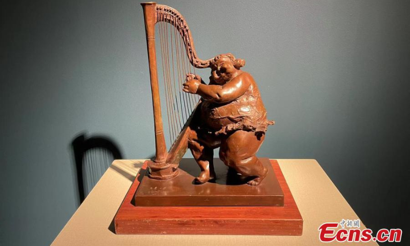 A sculpture which depicts a big woman playing a musical instrument by Xu Hongfei is on display at the National Center for the Performing Arts, July 3, 2022. (Photo: Ecns.cn/Zhang Dongfang)