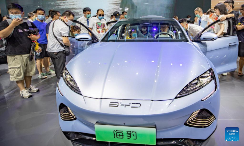 Visitors view a new energy vehicle during the 2022 Chongqing International Auto Exhibition in southwest China's Chongqing Municipality, June 25, 2022.