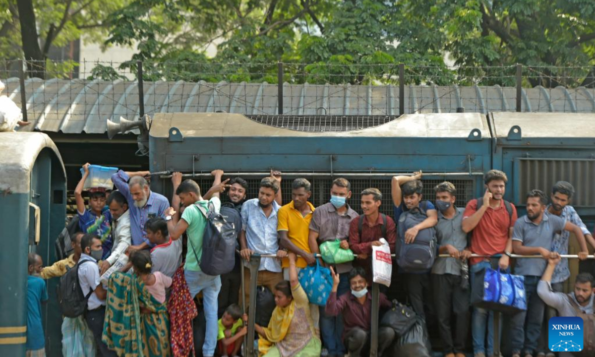 People cling to train carriages as they head to their homes to celebrate Eid al-Adha festival, from Dhaka, Bangladesh, July 7, 2022. As Eid al-Adha festival approaches, many people from Bangladesh capital Dhaka have streamed out of the city to join the festival with their kith and kin in village homes. Photo:Xinhua