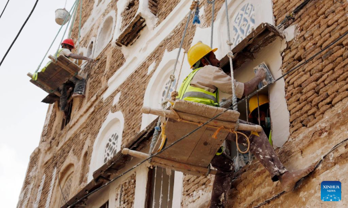 Architects work on renovating historical buildings in Old Sanaa City, Yemen, on July 5, 2022. The old city of Sanaa was inscribed on the World Heritage List of the UNESCO in 1986. The old city has been inhabited for more than 2,500 years. The 6,000 mud-brick tower houses are decorated with geometric patterns of white plaster and stained glass windows. Photo:Xinhua