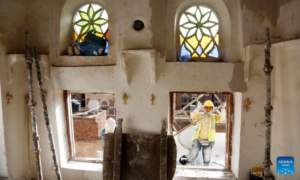 Architects work on renovating historical buildings in Old Sanaa City, Yemen, on July 5, 2022. The old city of Sanaa was inscribed on the World Heritage List of the UNESCO in 1986. The old city has been inhabited for more than 2,500 years. The 6,000 mud-brick tower houses are decorated with geometric patterns of white plaster and stained glass windows. Photo:Xinhua