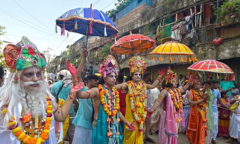 People in colorful costumes participate in a Rath Yatra Festival procession in Dhaka, Bangladesh on July 1, 2022.Photo:Xinhua