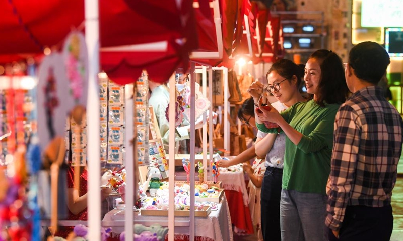 People choose commodities at a commercial street in southwest China's Chongqing Municipality, June 5, 2022.Photo:Xinhua