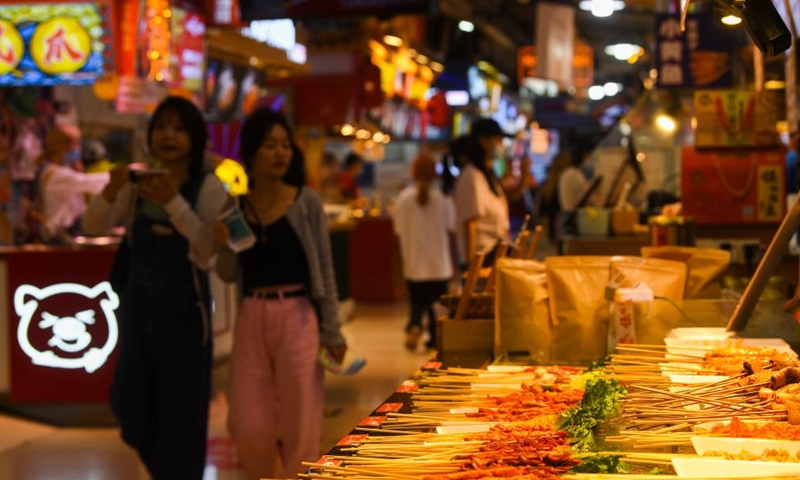 People tour a snack street in southwest China's Chongqing Municipality, June 5, 2022.Photo:Xinhua