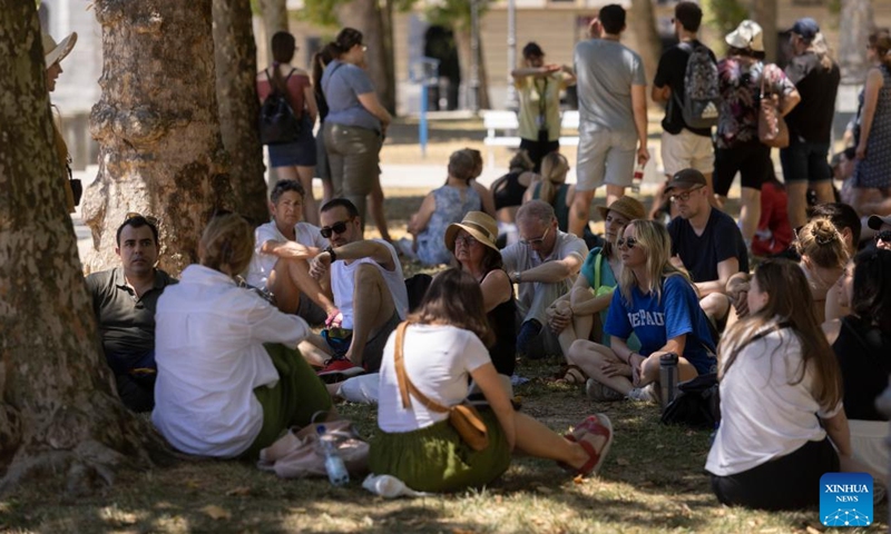 People rest in the shade of trees from the sun at a park in Ljubljana, capital of Slovenia, July 3, 2022.Photo:Xinhua