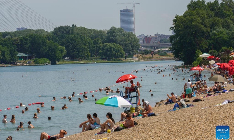 People spend time at the lakeside in Belgrade, Serbia, on July 5, 2022. Serbia witnessed hot weather recently.(Photo: Xinhua)