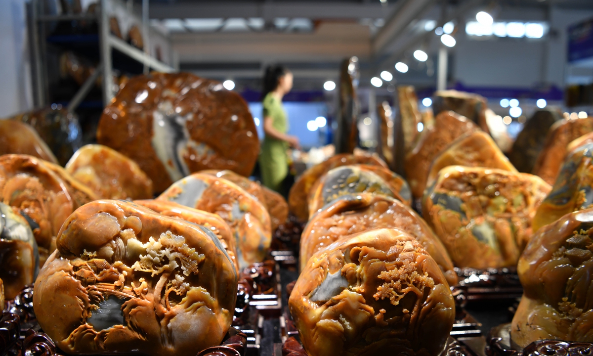 Huanglong jade carving works seen at the China Kunming International Stone Expo in Kunming, Southwest China's Yunnan Province which opened on July 7, 2022. The five-day expo has attracted more than 900 firms displaying treasures such as jadeite, agate and yellow dragon jade. Photo: cnsphoto