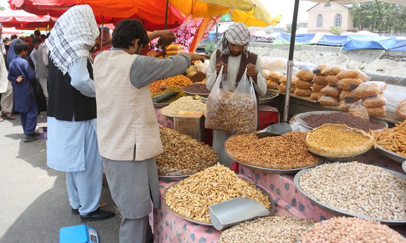 Locals buy dried fruits and nuts for the upcoming Eid al-Adha in Kabul, Afghanistan, July 6, 2022.Photo:Xinhua