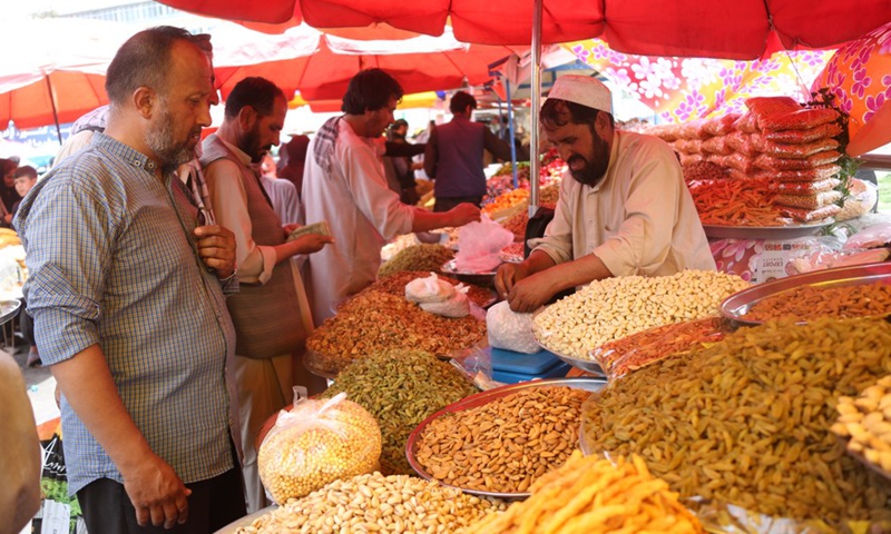 Locals buy dried fruits and nuts for the upcoming Eid al-Adha in Kabul, Afghanistan, July 6, 2022.Photo:Xinhua