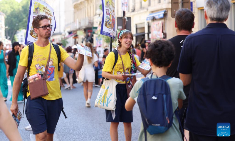 Artists promote their drama on the street during the 76th Festival d'Avignon in Avignon, France, July 19, 2022. (Xinhua/Gao Jing)