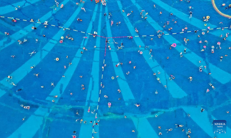 Aerial photo taken on July 16, 2022 shows tourists swimming in a pool in Qidong, east China's Jiangsu Province. (Xinhua/Ji Chunpeng)