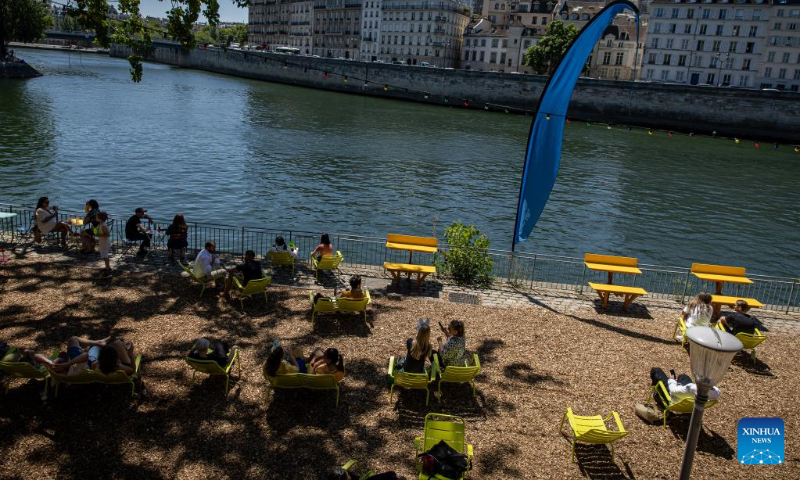 People enjoy the annual Paris Plages city beach event along the bank of the Seine in Paris, France, July 11, 2022. The Paris Plages city beach event is held from July 9 to Aug. 21 this year, offering events and activities on the banks of the Seine and the Bassin de la Villette. (Photo by Aurelien Morissard/Xinhua)