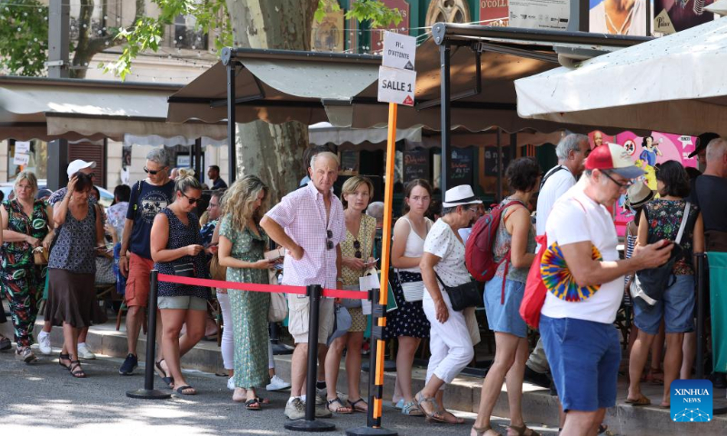 People line up outside a theater during the 76th Festival d'Avignon in Avignon, France, July 19, 2022. (Xinhua/Gao Jing)