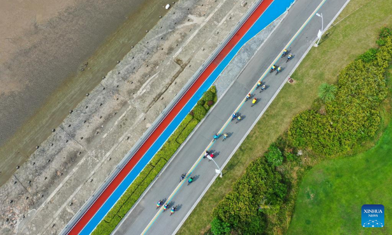 Aerial photo taken on July 17, 2022 shows tourists riding bikes in Qidong, east China's Jiangsu Province. (Xinhua/Ji Chunpeng)