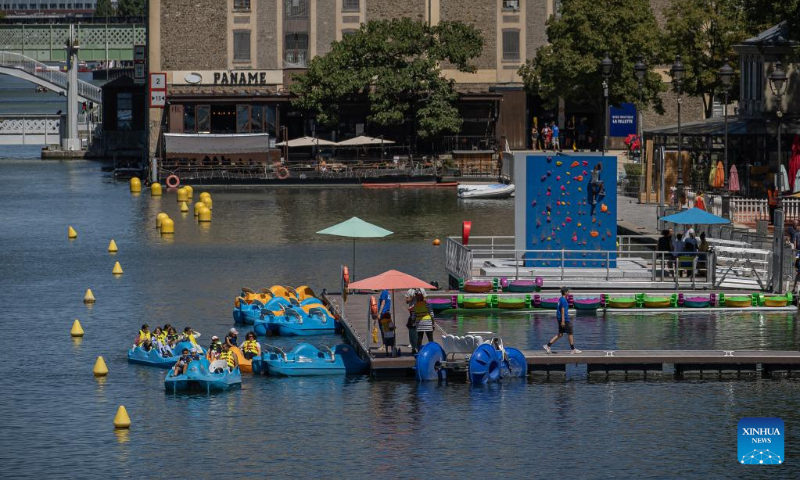 People enjoy the annual Paris Plages city beach event along the banks of the Bassin de la Villette in Paris, France, July 11, 2022. The Paris Plages city beach event is held from July 9 to Aug. 21 this year, offering events and activities on the banks of the Seine and the Bassin de la Villette. (Photo by Aurelien Morissard/Xinhua)