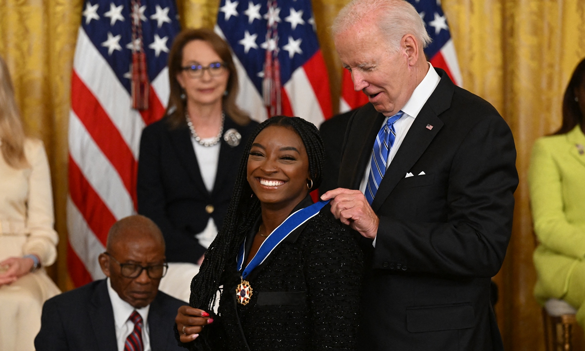 US President Joe Biden presents gymnast Simone Biles with the Presidential Medal of Freedom during a ceremony in Washington DC on July 7, 2022. Photo: AFP