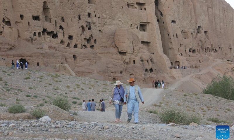 Tourists visit the site of the giant Buddha ruins in Bamiyan province, Afghanistan, July 10, 2022. Once a popular destination for tourists, Afghanistan's central Bamiyan province has been gradually recovering from the war aftermath to attract sightseers, but the scarcity of accommodations has become a new problem.(Photo: Xinhua)