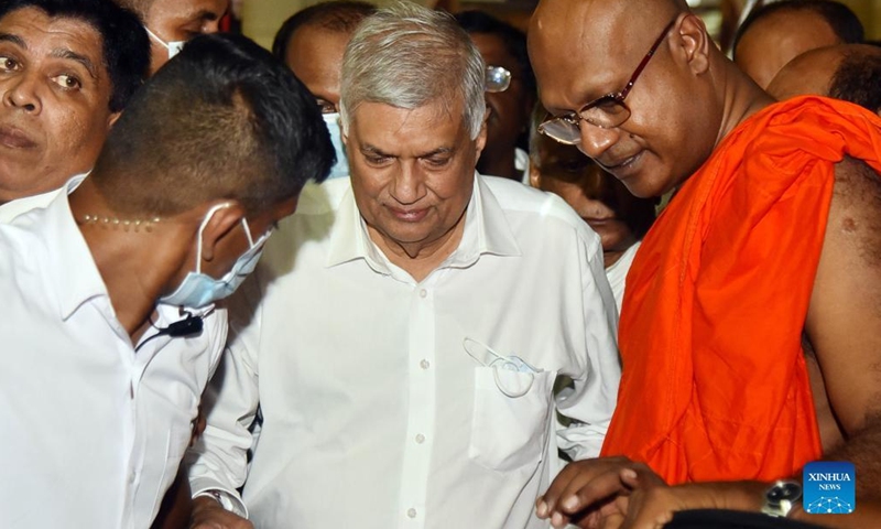 Ranil Wickremesinghe (C) visits a Buddhist temple in Colombo, Sri Lanka, on July 20, 2022. Acting President Ranil Wickremesinghe was elected as the new president of Sri Lanka in an election held in parliament on Wednesday.(Photo: Xinhua)