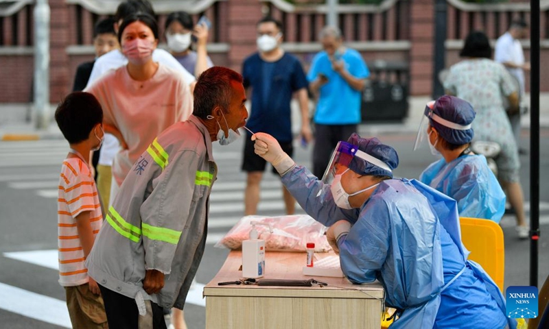 A medical worker takes a swab sample from a citizen for nucleic acid testing at Heping District in Tianjin, north China, July 24, 2022. (Xinhua/Sun Fanyue)