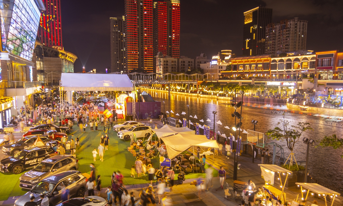 Residents enjoy the 2022 Nanhai Shopping Festival and the third Nanhai Automobile&Food Carnival in Foshan, South China's Guangdong Province on July 16, 2022. 100 car booths and 52 food booths were set up at the event site, with popular themed zones such as outdoor camping, a trunk market, road coffee, and specialty food and beverages. Photo: VCG