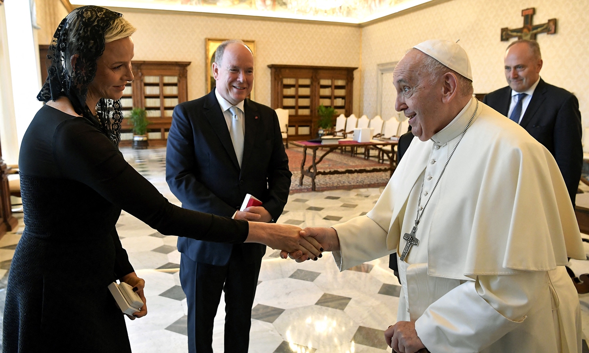 Monaco's Prince Albert II (second from left) looking at his wife Princess Charlene of Monaco shaking hands with Pope Francis at the end of a private audience at the Vatican on July 20, 2022. Photo: AFP