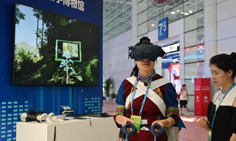 A visitor tours a digital museum via a VR device at a special exhibition of the 5th Digital China Summit in Fuzhou, southeast China's Fujian Province, July 22, 2022. A special exhibition was held here on Friday as part of the 5th Digital China Summit, displaying the latest achievements in building a digital China over the last five years.  Photo: Xinhua