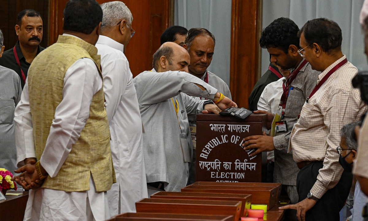 Officials on election duty open a ballot box during the counting of votes for the election of India's 15th President at the Parliament House in New Delhi on July 21, 2022. Photo: AFP
