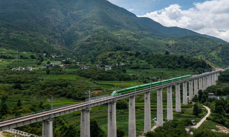 Aerial photo taken on July 22, 2022 shows a Fuxing bullet train running on a bridge in the Dali-Baoshan section of the Dali-Ruili Railway in southwest China's Yunnan Province. Baoshan in southwest China's Yunnan Province is no longer a city without rail links after the Dali-Baoshan section of the Dali-Ruili Railway officially went into operation on Friday. Photo: Xinhua