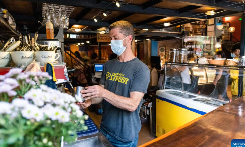 Colin Flahive makes coffee at Salvador's cafe in Kunming, southwest China's Yunnan Province, July 11, 2022. Photo: Xinhua