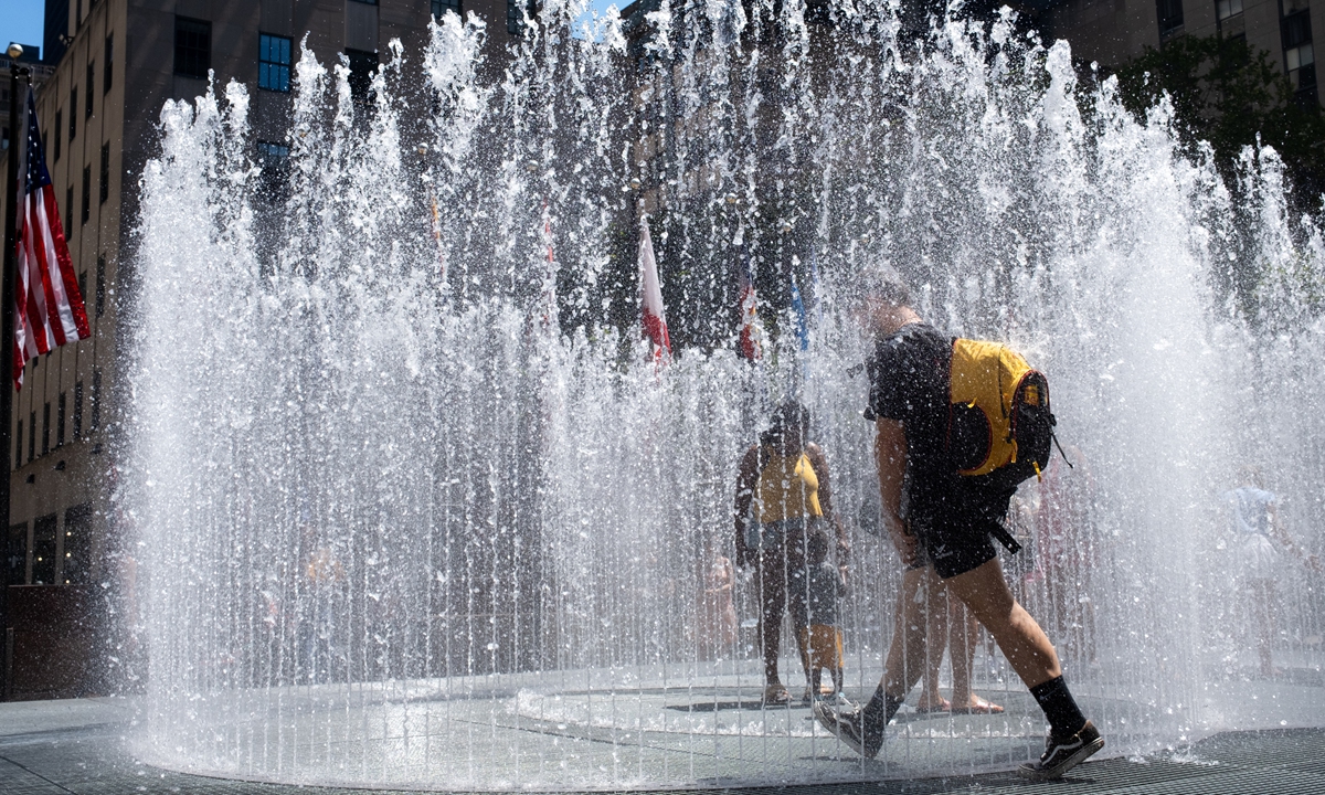  A person walks through the Changing Spaces fountain by Jeppe Hein at Rockefeller Center during a heat wave on July 23, 2022 in New York City. The five boroughs of New York City are under a heat advisory until 8 PM on July 24th according to the US National Weather Service. 