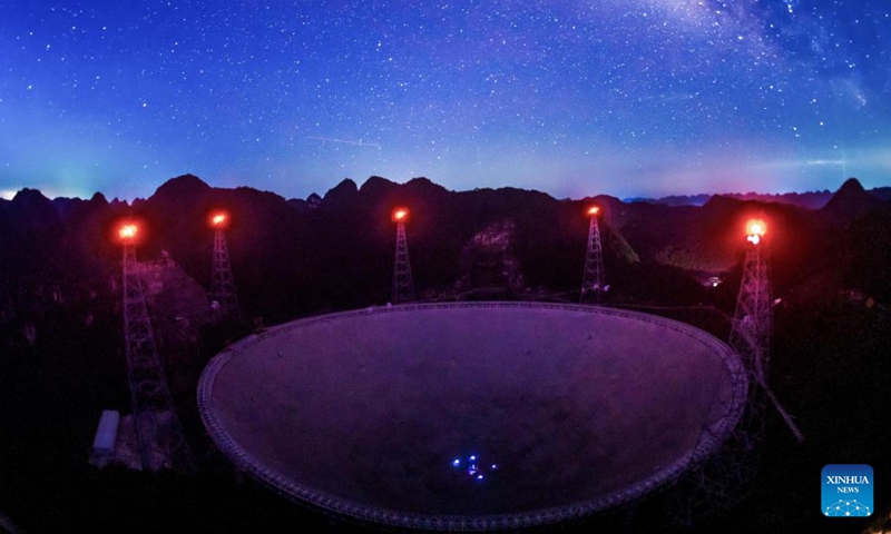 The long-time exposure photo taken on July 24, 2022 shows China's Five-hundred-meter Aperture Spherical Radio Telescope (FAST) under maintenance in southwest China's Guizhou Province. Using FAST, or the China Sky Eye, scientists have identified over 660 new pulsars. (Xinhua/Ou Dongqu)