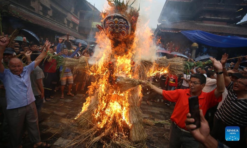 People observe the Ghantakarna Festival in Bhaktapur, Nepal, July 26, 2022. Members of the Newar community in the Kathmandu Valley observe the festival to chase away evil spirits and usher in good fortune. (Photo by Sulav Shrestha/Xinhua)