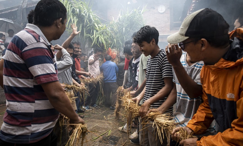 People pull the dummy of Demon Ghantakarna in Bhaktapur, Nepal, on July 26, 2022.(Photo: Xinhua)