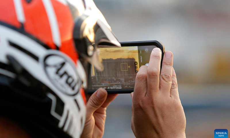 A man takes a photo of the Beirut port grain silos after its northern part collapsed in Beirut, Lebanon, July 31, 2022. The northern part of the Beirut port grain silos collapsed on Sunday after being on fire for weeks, causing a huge cloud of dust, the National News Agency reported. Photo: Xinhua