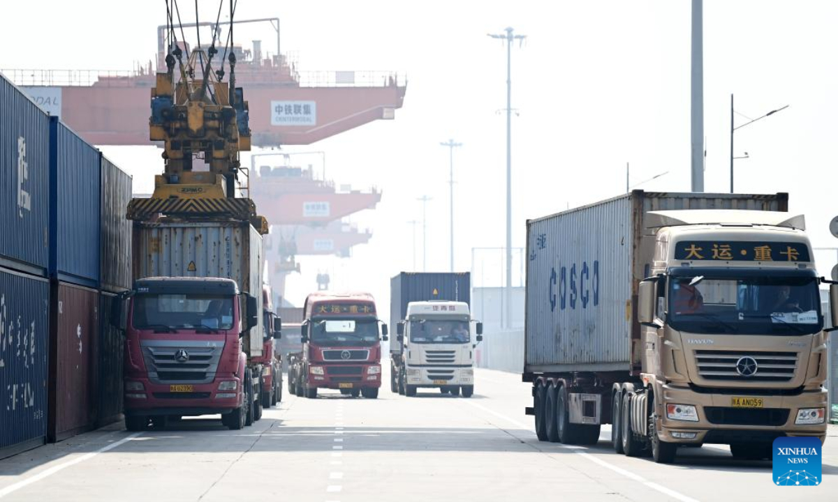 Trucks transport containers at Xi'an International Port in Xi'an, northwest China's Shaanxi Province, July 29, 2022. At present, Xi'an has 16 main freight train routes to Europe, passing through 45 countries and regions along the Belt and Road. Photo:Xinhua