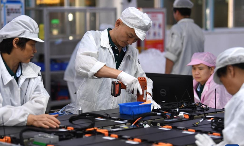 Workers work on a power battery production line at a workshop of a battery production company in Hefei Economic and Technological Development Area in Hefei, east China's Anhui Province, July 29, 2022. Photo: Xinhua 