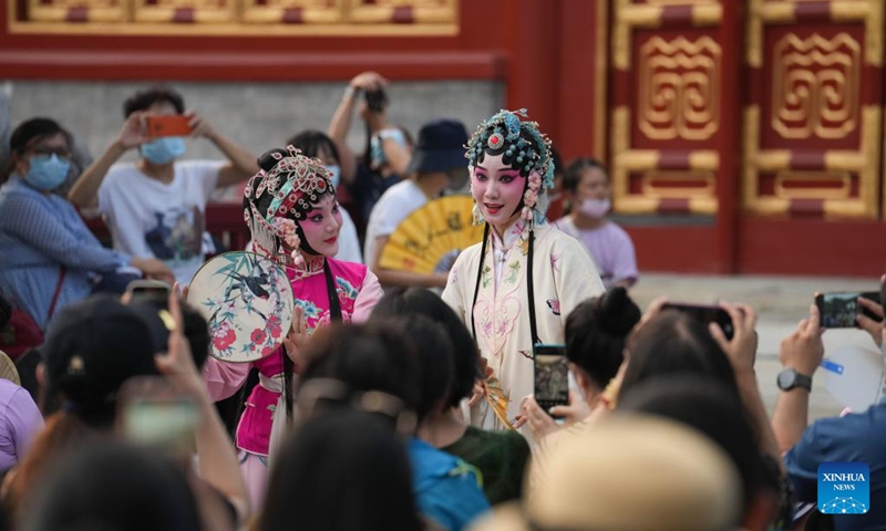 People watch a Kunqu opera performance at Miaoying Temple, also called Baita Temple, in Beijing, capital of China, July 30, 2022. A series of cultural activities will be held at night at Miaoying Temple recently. (Xinhua/Ju Huanzong)