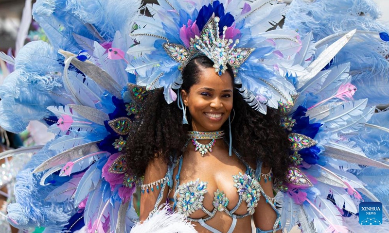 A dressed-up participant poses for photos during the Grand Parade of the 2022 Toronto Caribbean Carnival in Toronto, Canada, on July 30, 2022. More than 10,000 dressed-up participants took part in this annual event here on Saturday. (Photo by Zou Zheng/Xinhua)