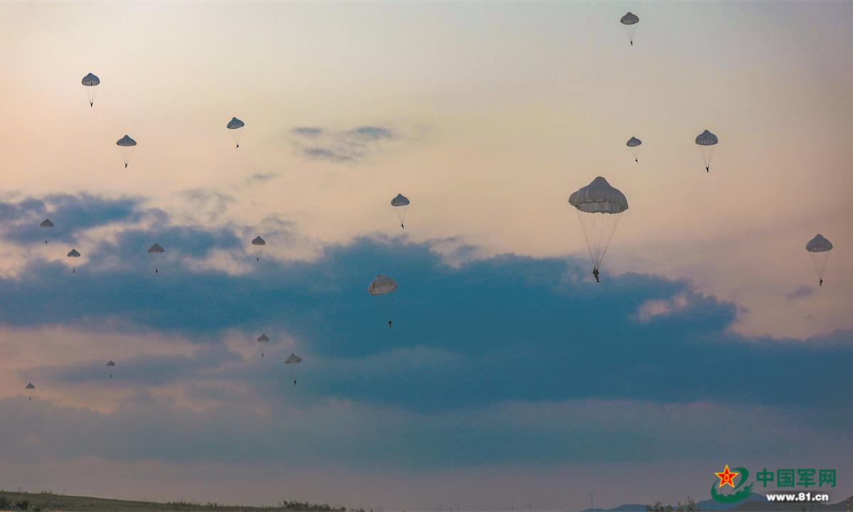 Special operations soldiers assigned to the Thunder Commando of the PLA Air Force airborne troops descend to the drop zone after bailing out of the aircraft during a parachuting training exercise in mid-summer, 2022. The exercise, lasting for several days, aims to hone the troops' combat capabilities in parachuting, long-range penetration and precision strike operations in the complex environment. Photo:China Military