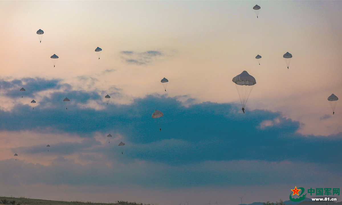 Special operations soldiers assigned to the Thunder Commando of the PLA Air Force airborne troops descend to the drop zone after bailing out of the aircraft during a parachuting training exercise in mid-summer, 2022. The exercise, lasting for several days, aims to hone the troops' combat capabilities lasting for several days, aims to hone the troops' combat capabilities in parachuting, long-range penetration and precision strike operations in the complex environment. (eng.chinamil.com.cn/Photo by Gu Xixi, Xu Jiawang and Guo Shuai)