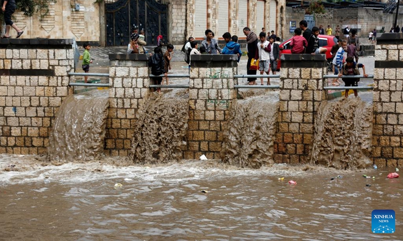 People gather on a flooded street after heavy rain in Sanaa, Yemen, on Aug. 1, 2022.(Photo: Xinhua)