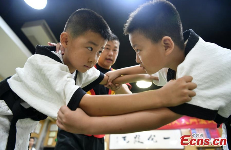 Teenagers practice Kungfu wrestling during the summer break at a training center in Shijiazhuang, north China's Hebei Province, Aug. 3, 2022. The Yang style Kungfu westling was founded in 1937 and included in the eighth batch of intangible cultural heritage list of Shijiazhuang in 2020. (Photo: China News Service/Zhai Yujia)