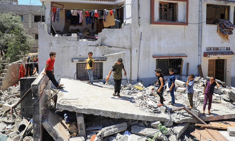 Relatives of Hassan Shamalakh, 69, stand over the rubbles of a house, in Gaza City, on Aug. 14, 2022.(Photo: Xinhua)