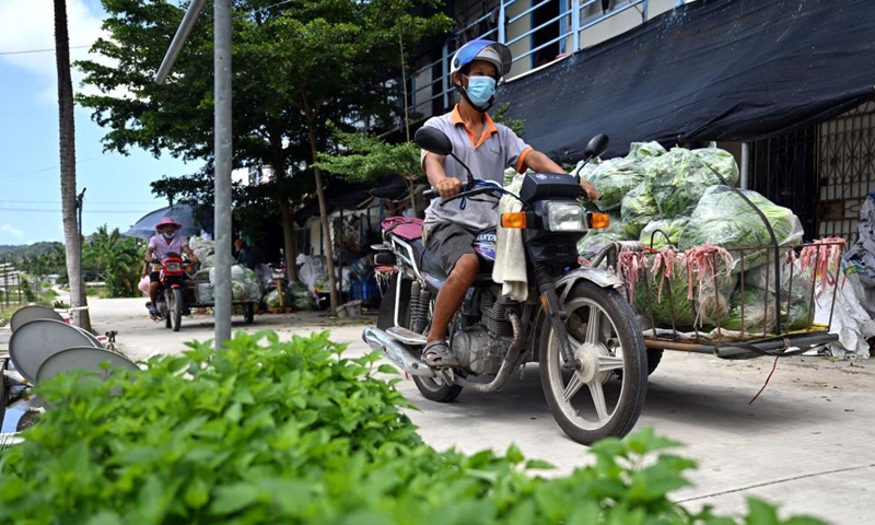 Farmers of a farming cooperative transport vegetables in Sanya, south China's Hainan Province, Aug. 22, 2022. The local government has strived to ensure the production, transportation, and sale of farming products while combating COVID-19. (Xinhua/Guo Cheng)