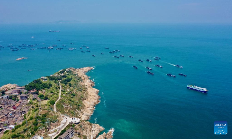 Aerial photo taken on Aug. 16, 2022 shows fishing boats sailing from the Huangqi fishing port in Lianjiang County of Fuzhou, southeast China's Fujian Province. Local fishermen began their fishing work as a three-and-a-half-month seasonal fishing ban was lifted at some sea areas in Fujian on Tuesday.(Photo: Xinhua)