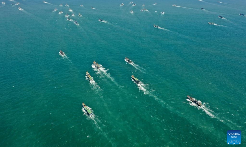 Aerial photo taken on Aug. 16, 2022 shows fishing boats sailing from the Huangqi fishing port in Lianjiang County of Fuzhou, southeast China's Fujian Province. Local fishermen began their fishing work as a three-and-a-half-month seasonal fishing ban was lifted at some sea areas in Fujian on Tuesday.(Photo: Xinhua)