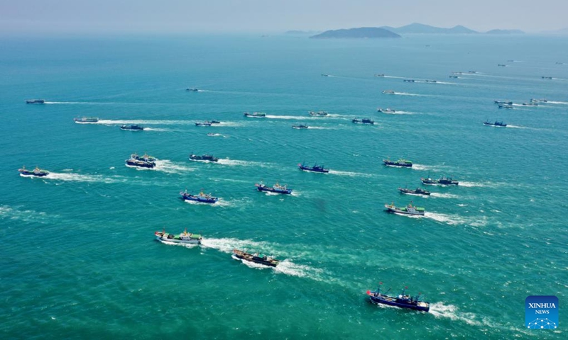 Aerial photo taken on Aug. 16, 2022 shows fishing boats sailing from the Huangqi fishing port in Lianjiang County of Fuzhou, southeast China's Fujian Province. Local fishermen began their fishing work as a three-and-a-half-month seasonal fishing ban was lifted at some sea areas in Fujian on Tuesday.(Photo: Xinhua)