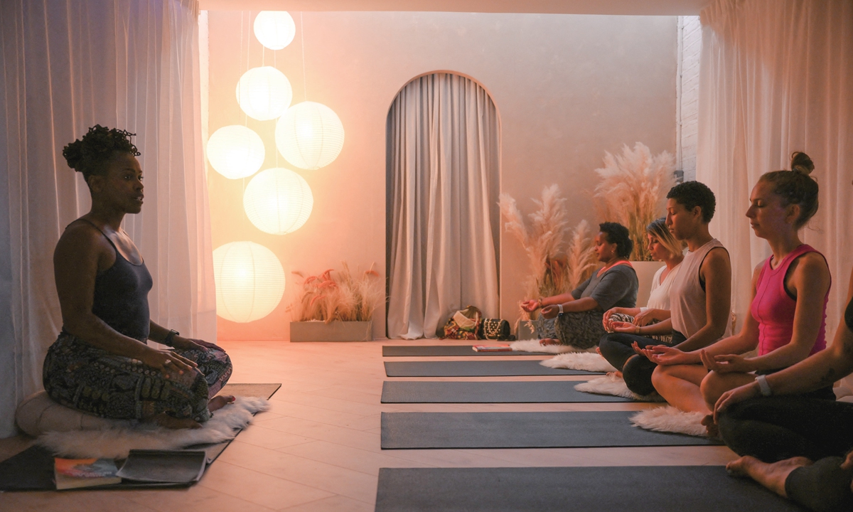 Yoga teacher and author Stacie Graham (left) gives a yoga session at the studio 