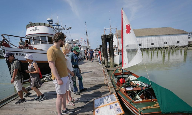 People look at a small boat during the 19th annual Richmond Maritime Festival in Richmond, British Columbia, Canada, on Aug. 20, 2022.Photo:Xinhua